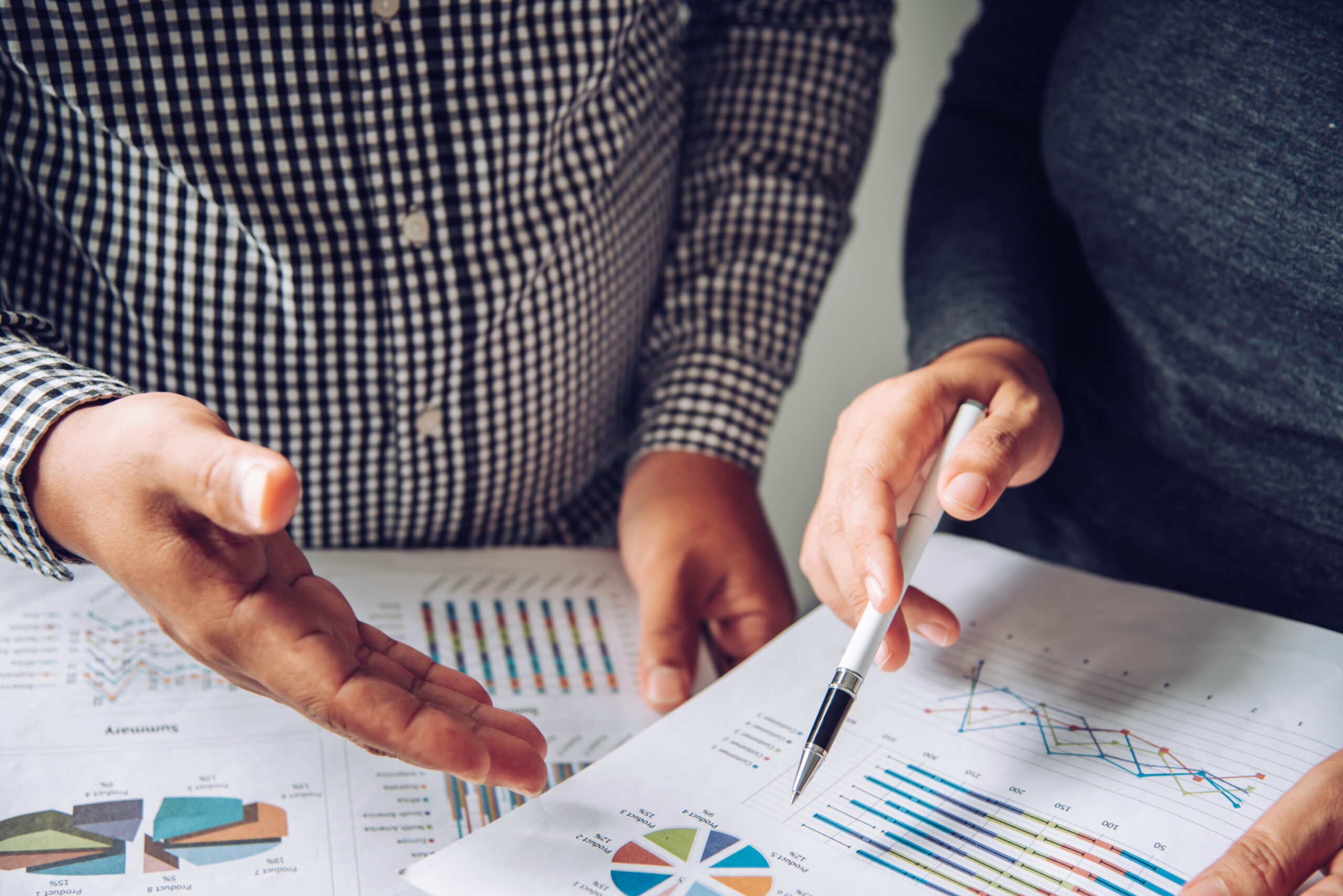 Business team working with documents, finance and graphs in an open office space